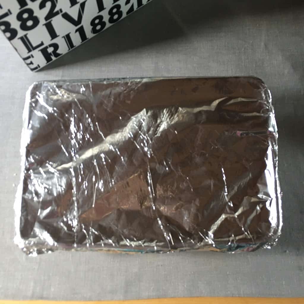 aluminum foil covering the lasagna and tightly sealed