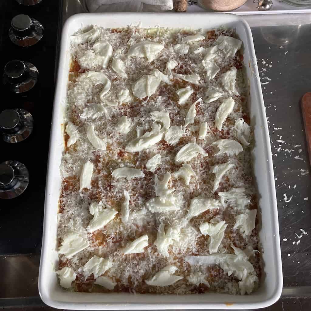 one entire ball of mozzarella shredded and dotted over the top of the lasagna