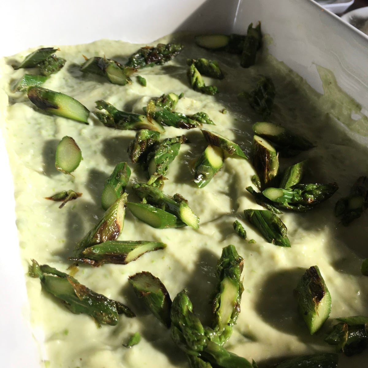 Asparagus bechamel with roasted asparagus on top layered into an italian lasagna recipe.