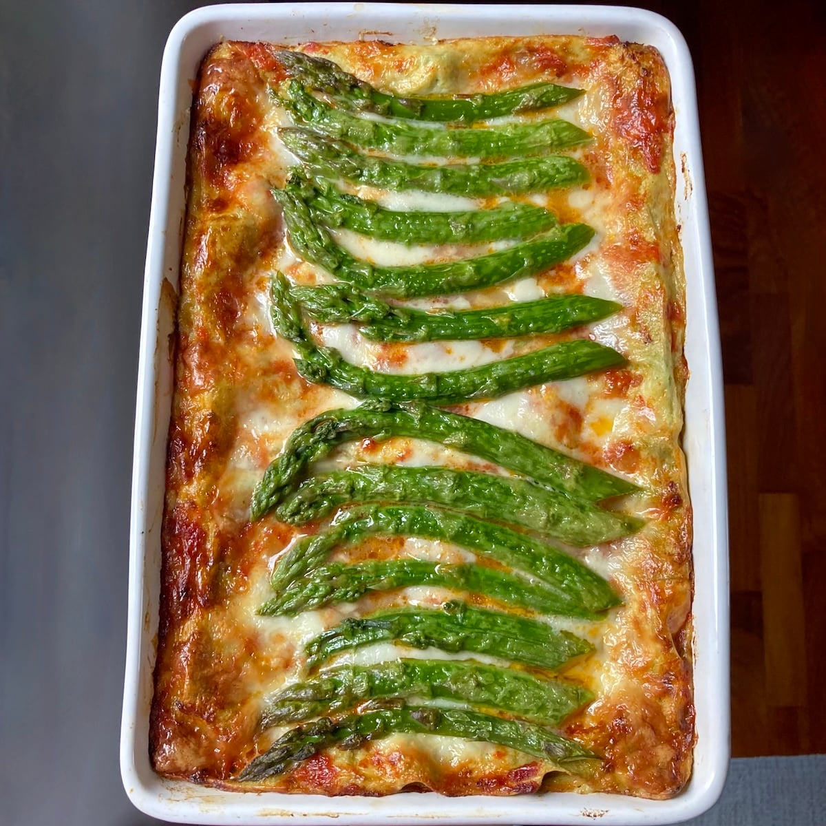An italian ham and asparagus lasagna fully baked with beautiful wild asparagus spears decorating the top of the cheesy crispy mozzarella topping.
