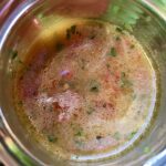 Beautiful tomato, herb, and onion vinaigrette in a jar top down view.