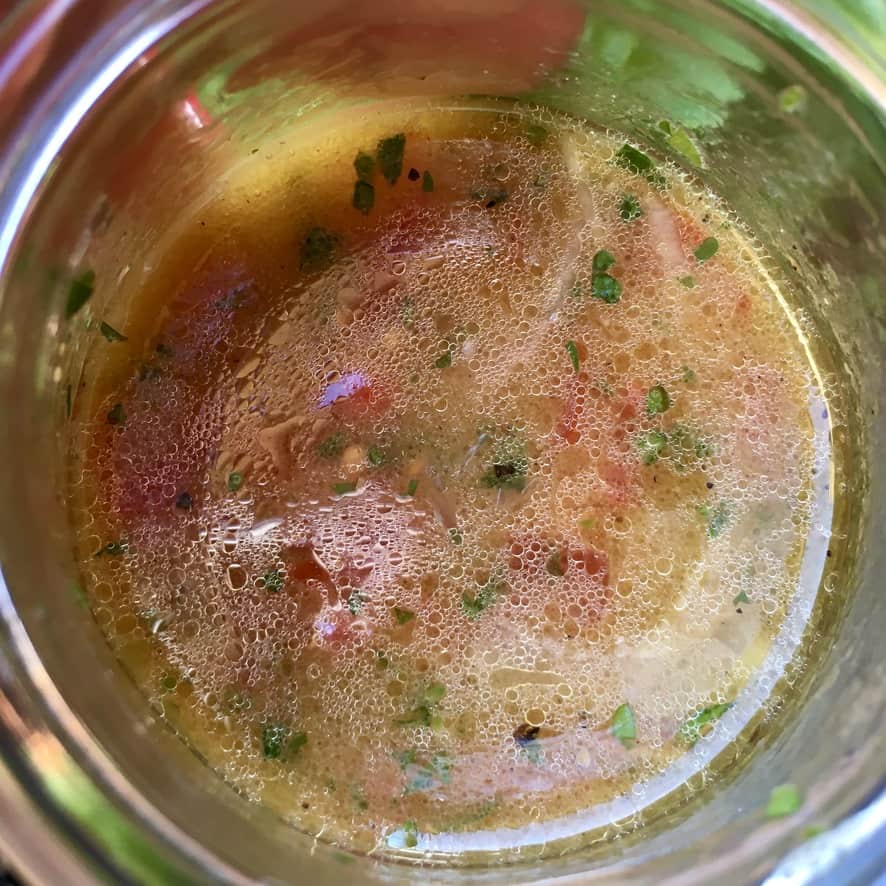 the mixed (orangish) vinaigrette blended in a jar