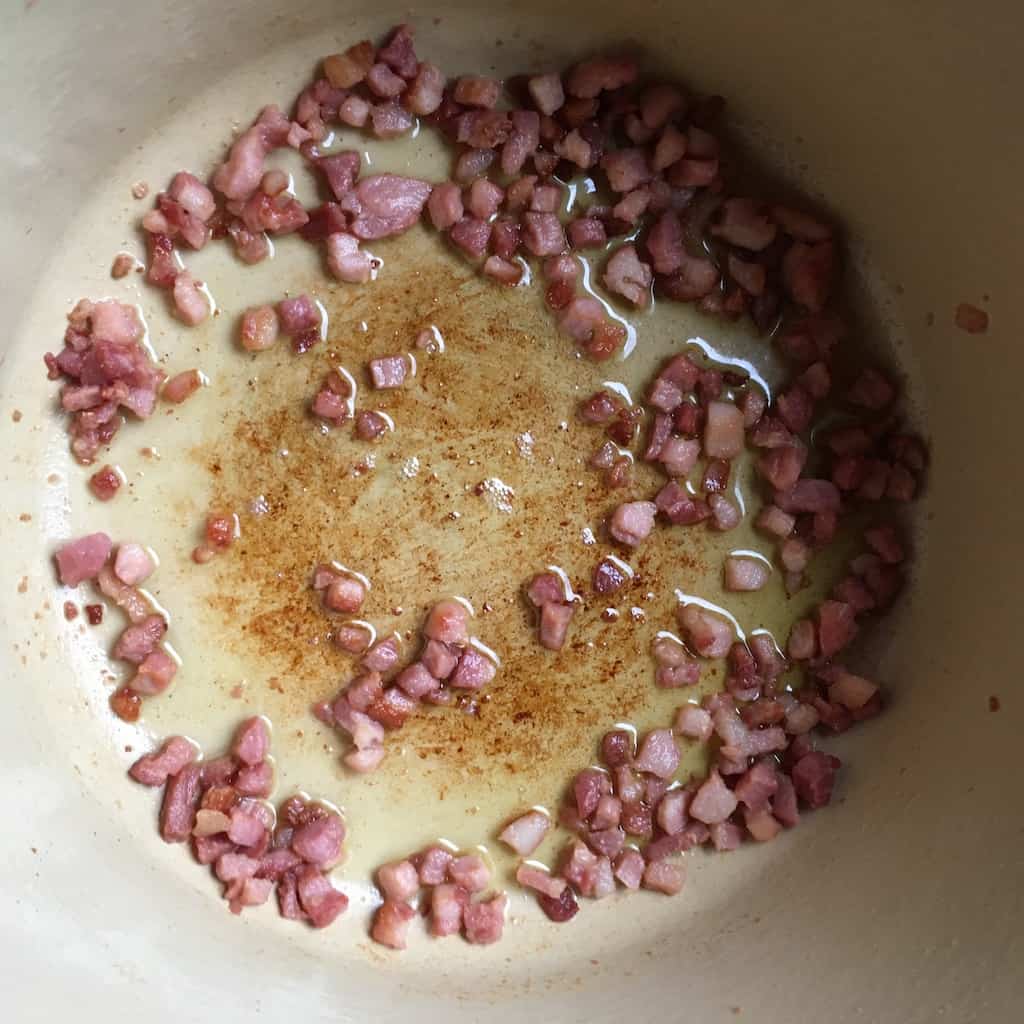 pancetta cubes starting to brown and render some of the fat in a dutch oven