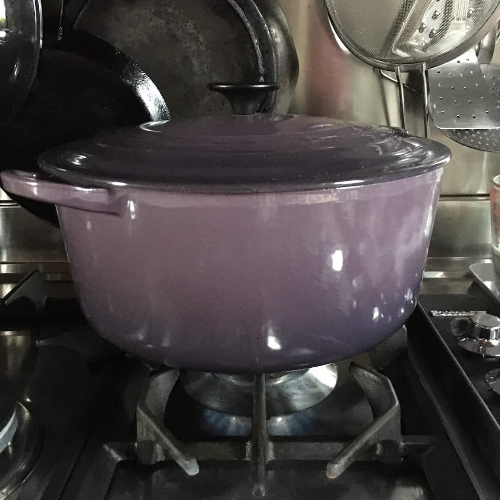 Simmering the bolognese sauce covered in a dutch oven