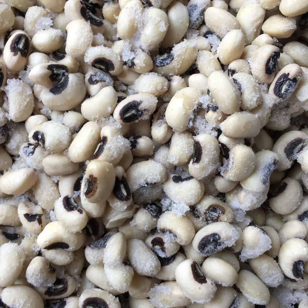 closeup shot of black eyed peas still frozen from when I meal prep them by soaking overnight and freezing so I always have fresh peas and beans ready to be cooked at a moment's notice