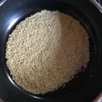 sesame seeds in a skillet starting to toast