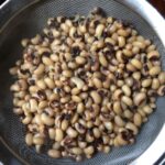 cooked black-eyed peas in the strainer (sieve) just after cooking