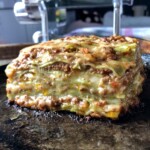 A traditional size square of lasagna bolognese with 8 layers with perfectly portioned layers and thinner lasagna sheets.