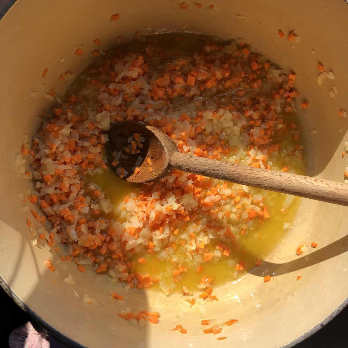 Finely diced carrots added to the translucent onions in the Dutch oven for the soffrito base, easy bolognese sauce recipe building layers of flavor for the best bolognese sauce.
