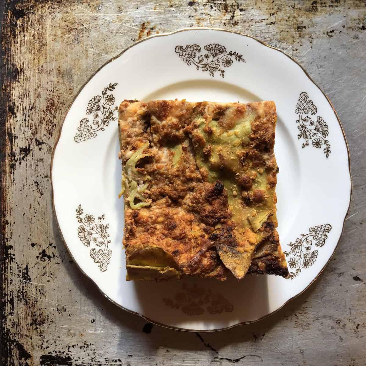 A cold square of lasagna bolognese from Macelleria Agnoletto and Bignami in Bologna Italy ready to be reheated, authentic Italian bolognese sauce and bechamel layered lasagna used for recipe research.
