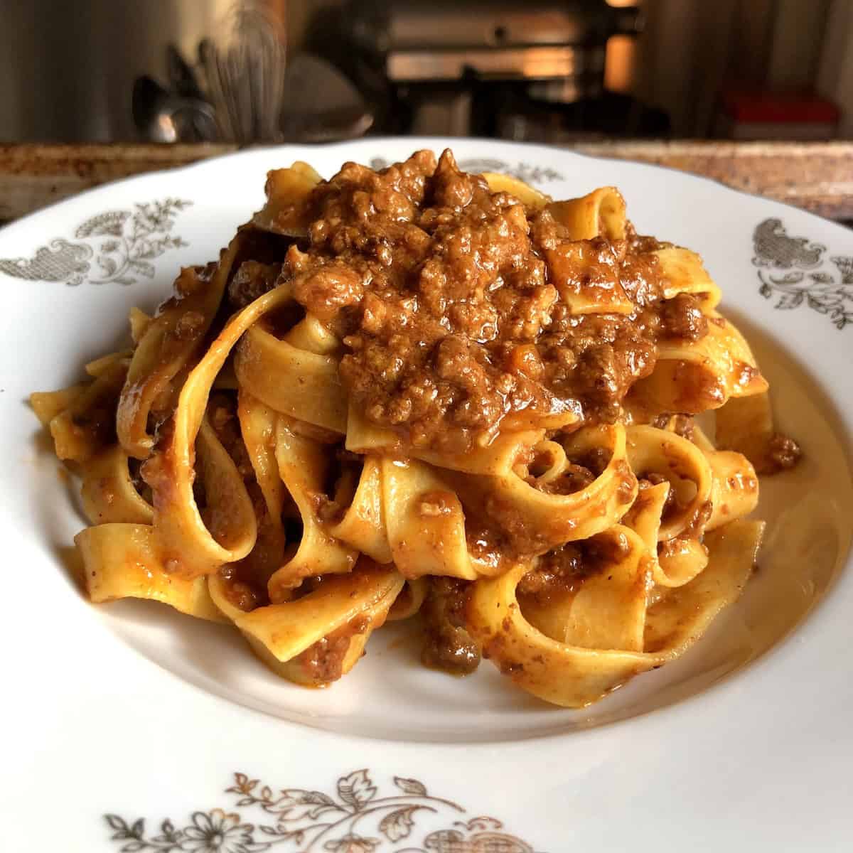 A bowl of pappardelle bolognese with homemade bolognese sauce ready to eat, showing an authentic ragu bolognese.