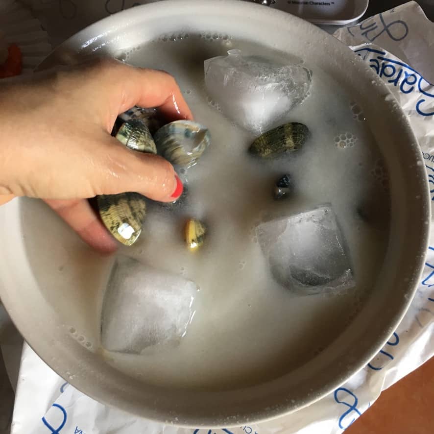 Step 7: Spaghetti added directly to the clam sauce pan, tossed with tongs to finish cooking in the clam broth.