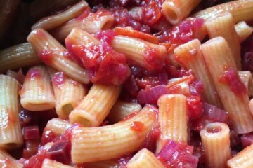 closeup of fresh egg maccheroni pasta with purple and red sauce