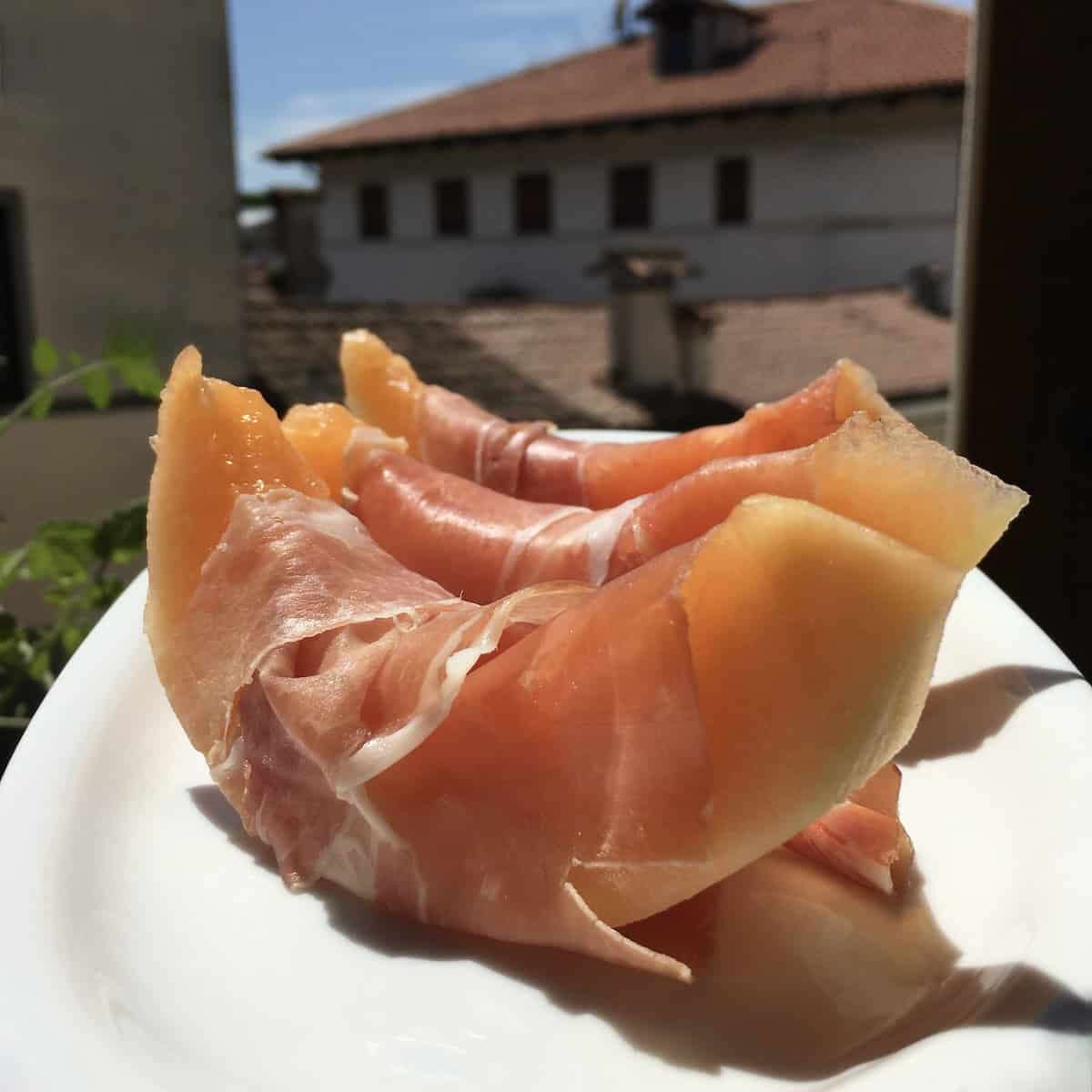 Italian 24-month aged prosciutto crudo wrapped around smooth white "liscio" (meaning smooth) cantaloupe melon wedges, brunch appetizers and brunch menu ideas for Mother's Day.