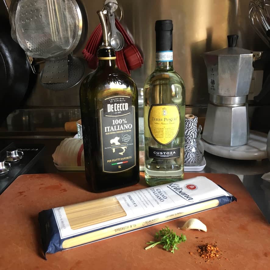 Step 1: Heating olive oil and garlic in a wide saute pan for spaghetti alle vongole clam pasta sauce.