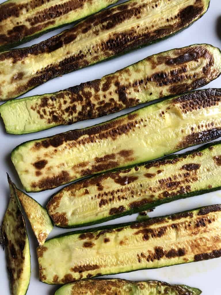 perfectly pan-seared golden brown zucchini on a platter