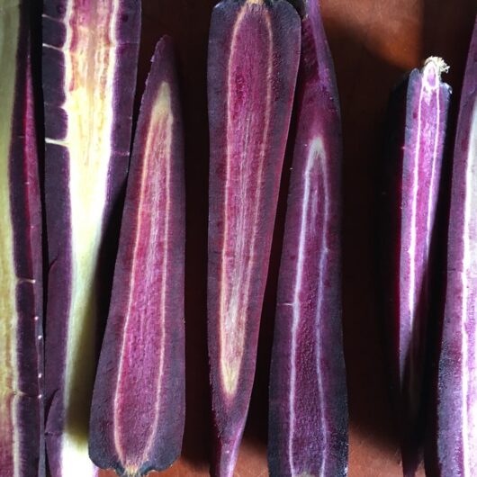 purple carrots peeled and sliced in half to reveal their dark purple or pale yellow (or combo of both!) interior
