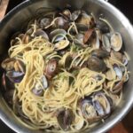 a beautiful pan full of clammy clammy spaghetti alle vonole or spaghetti with clams ready to be eaten