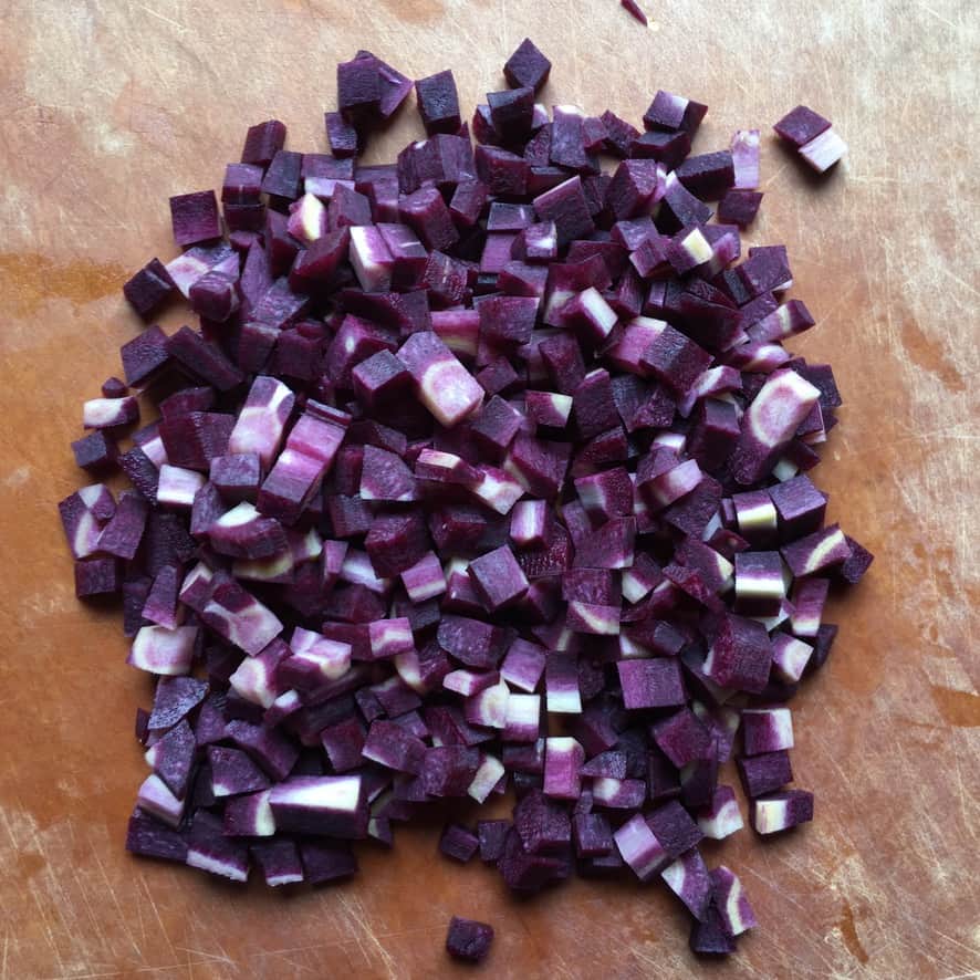 diced purple carrots on a cutting board in a pile looking super duper purple!