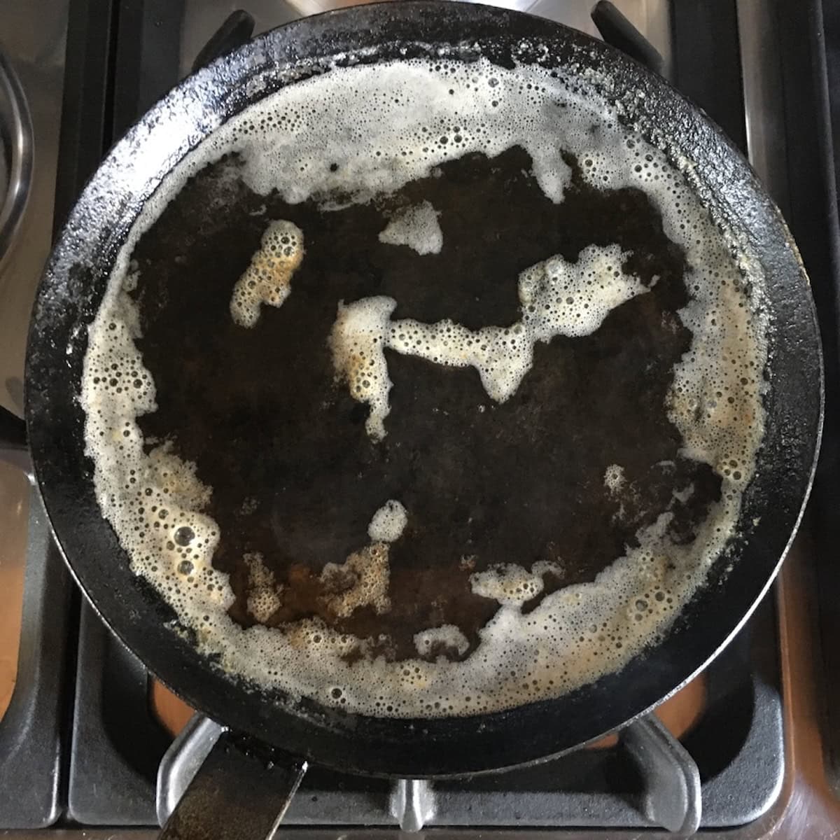 Toasted brown butter with nutty bubbles ready to add to crepe batter recipes as a key crepe ingredients step for the best sweet crepe recipe or savory crepe recipe.