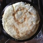 Homemade crepes cooking in a De Buyer carbon steel crepe pan.