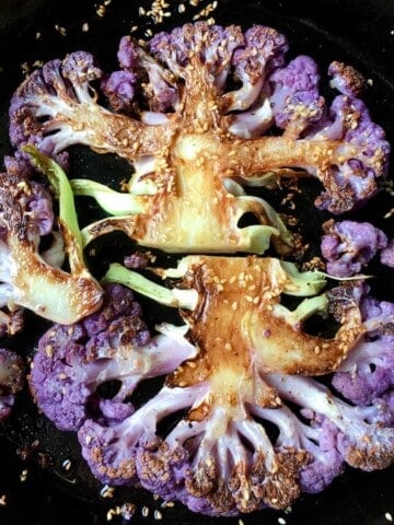 Purple cauliflower steaks perfectly crispy and tender with a crispy sesame seed crust.