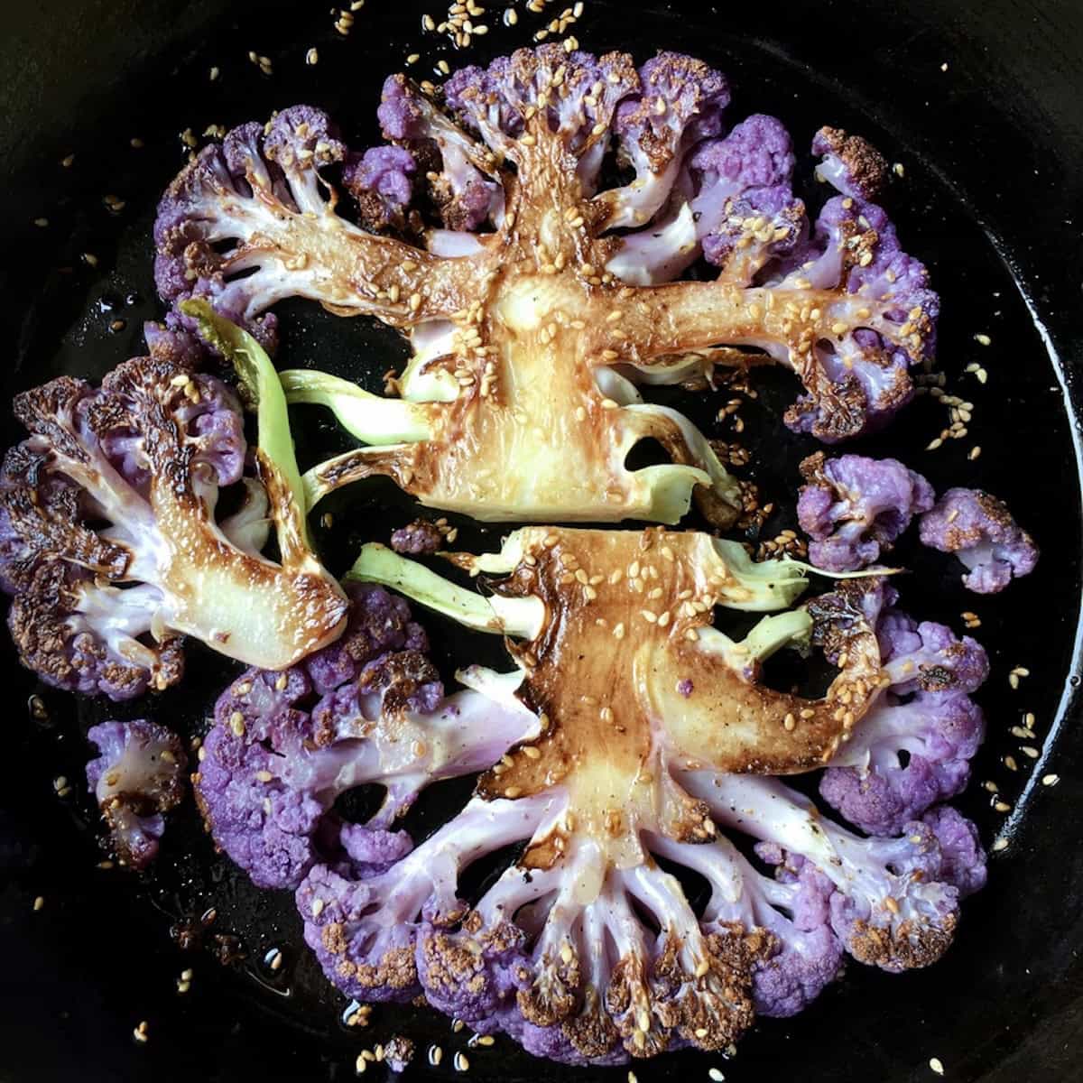 Purple cauliflower steaks perfectly crispy and tender with a crispy sesame seed crust.
