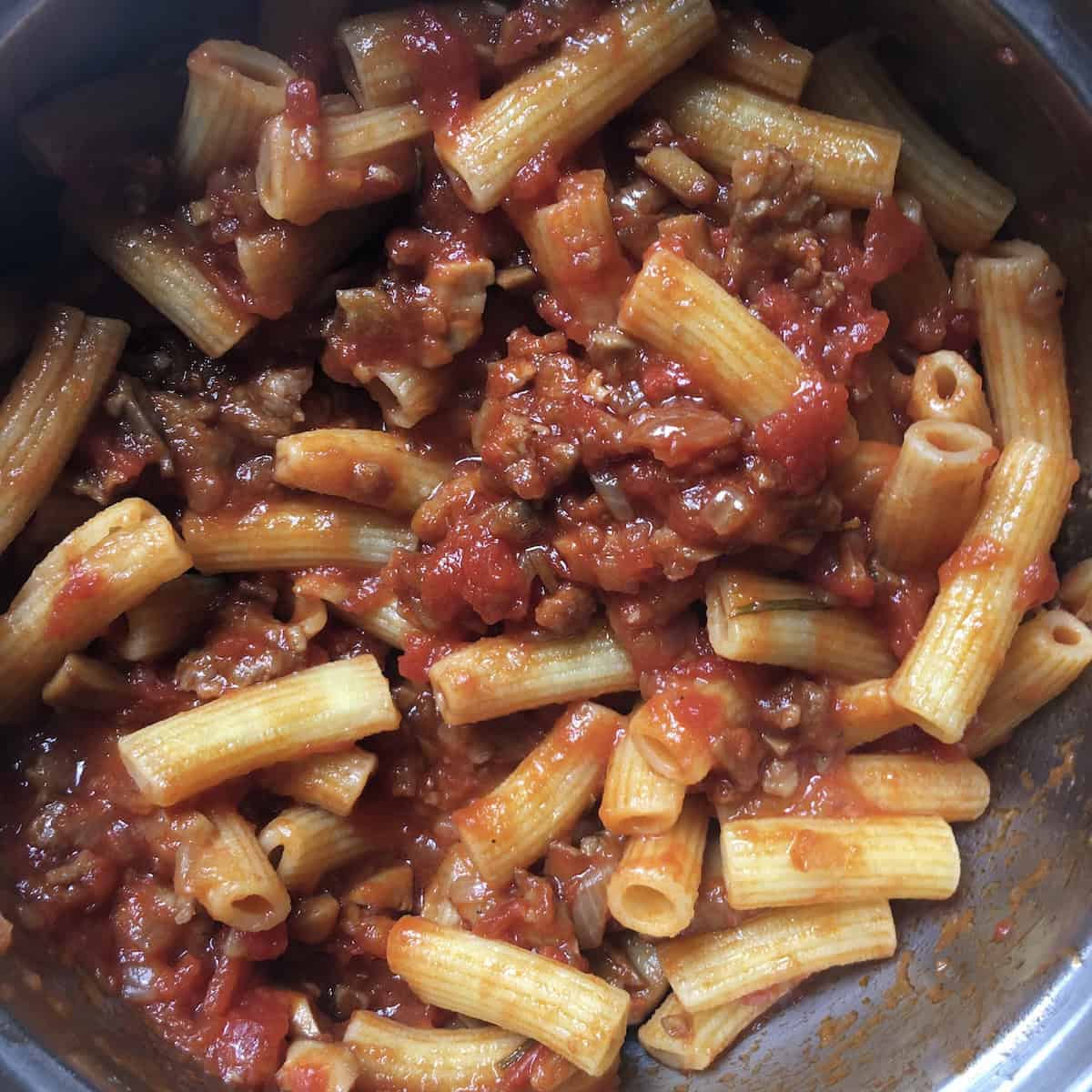 Sausage and Mushroom Maccheroni Pasta in the pot looking scrumptious and glistening with tomato sauce.