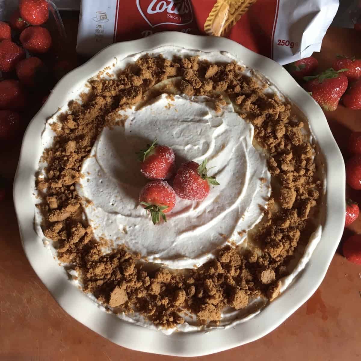 A strawberry mille crepe cake inspired dessert crepes layered with biscoff cookies, crepe cake filling, and fresh sugared strawberries for this strawberry crepes and crepe cake recipes idea.
