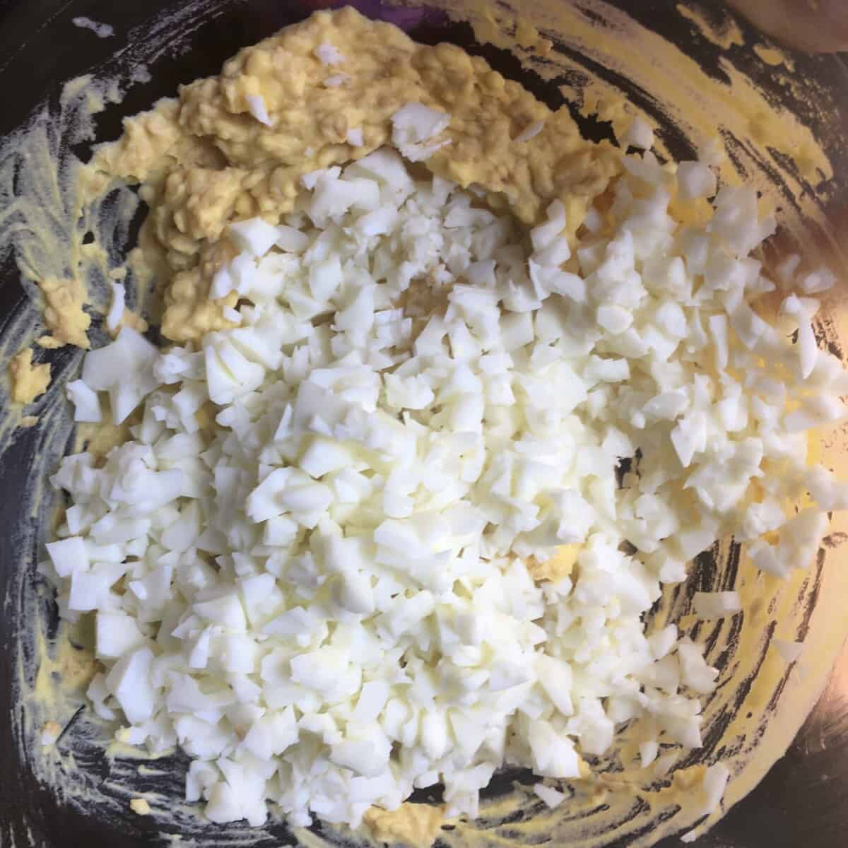 finely diced egg whites added to the yolk mixture but not yet stirred in
