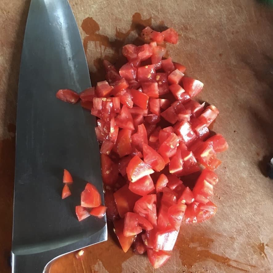 diced tomatoes on a cutting board
