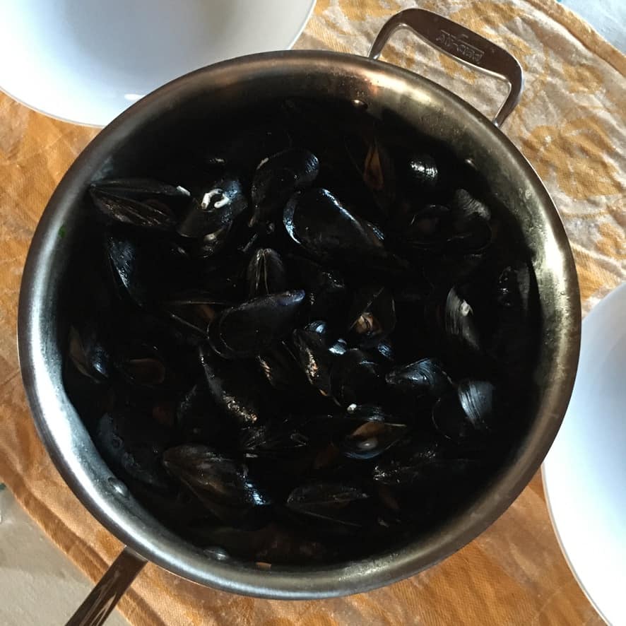 the mussels added back to the pan to serve