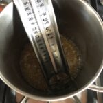 a candy thermometer in the hot syrup