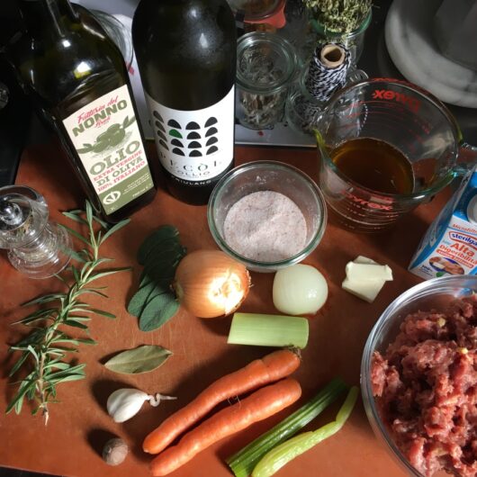Italian Duck Ragu raw ingredients on a cutting board