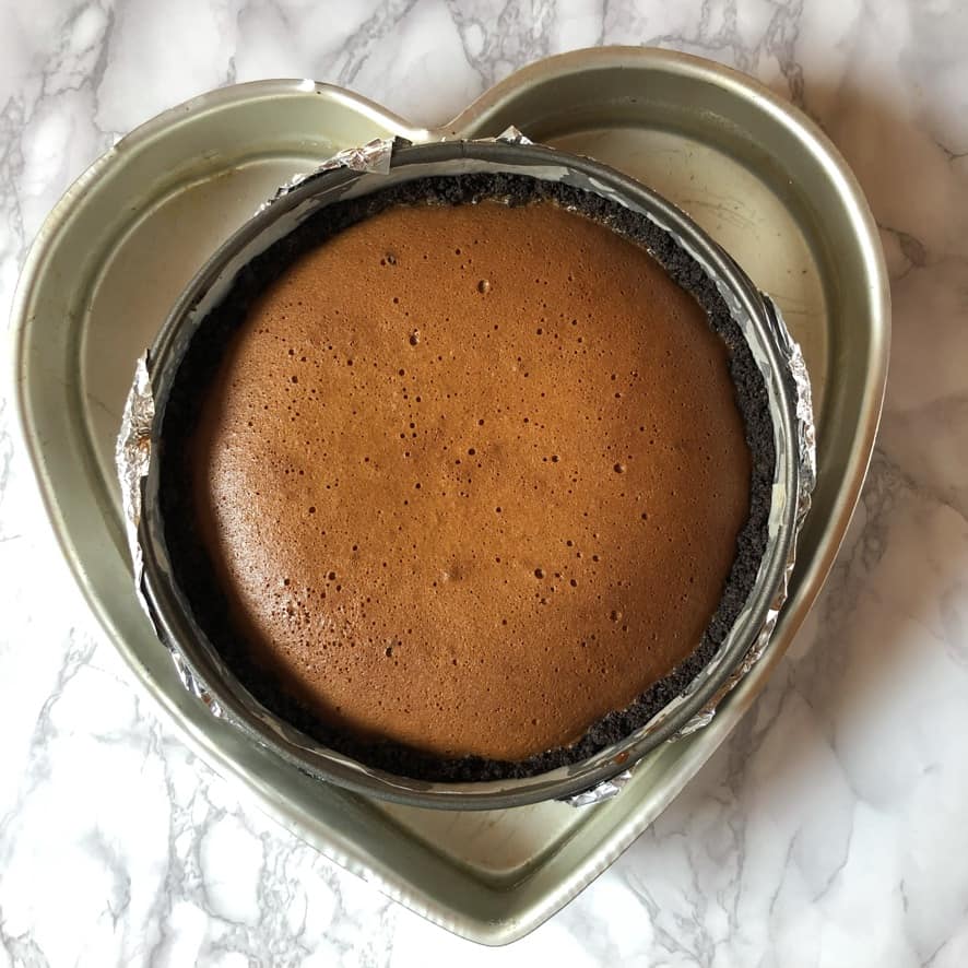 Baked caramel cheesecake in the springform pan, still slightly puffed.