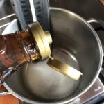 Adding golden syrup to the pot with sugar