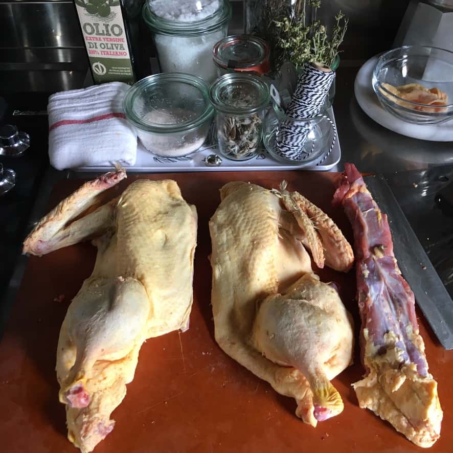 duck cut in half lying on a cutting board