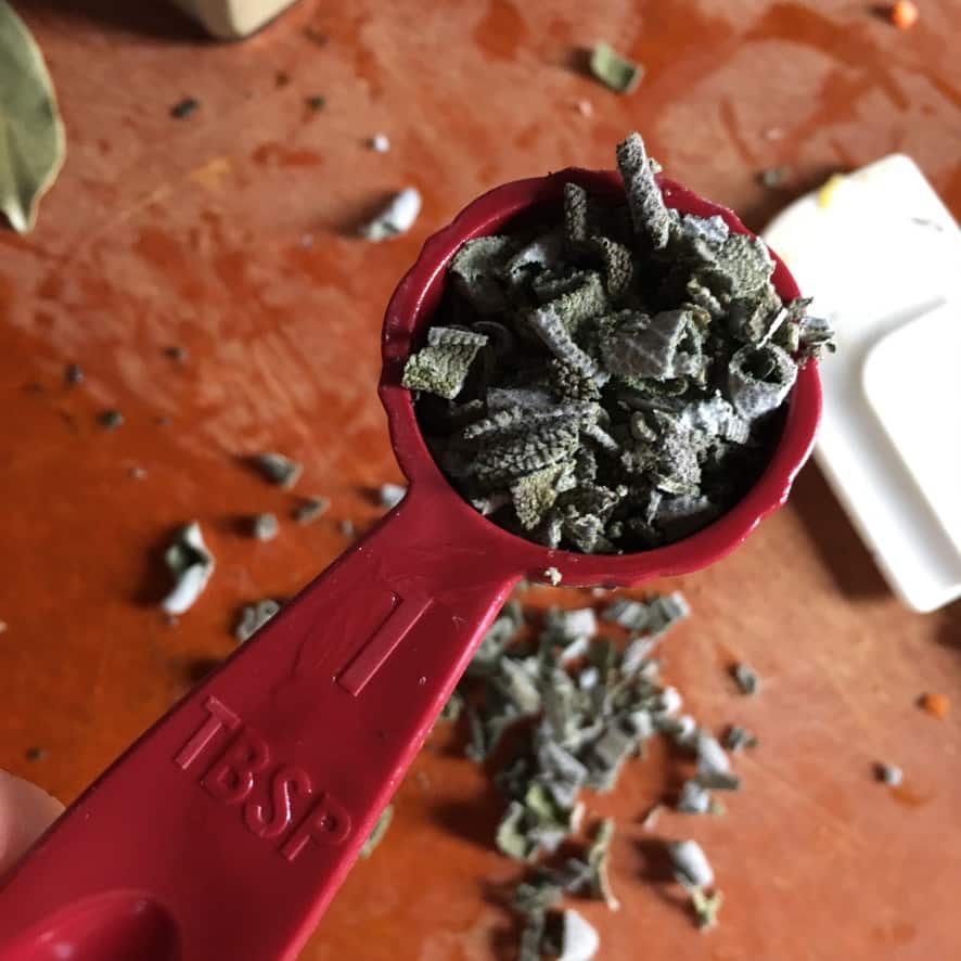 dried homemade rubbed sage in a tablespoon