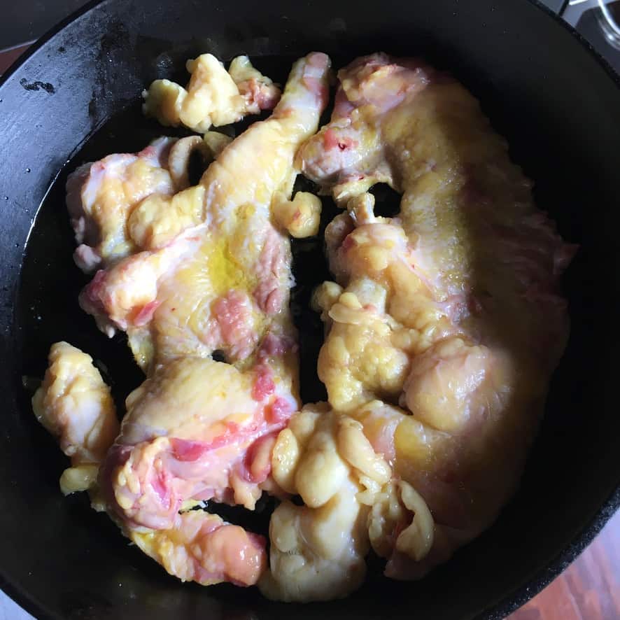 duck skins and fat rendering in a cast iron skillet
