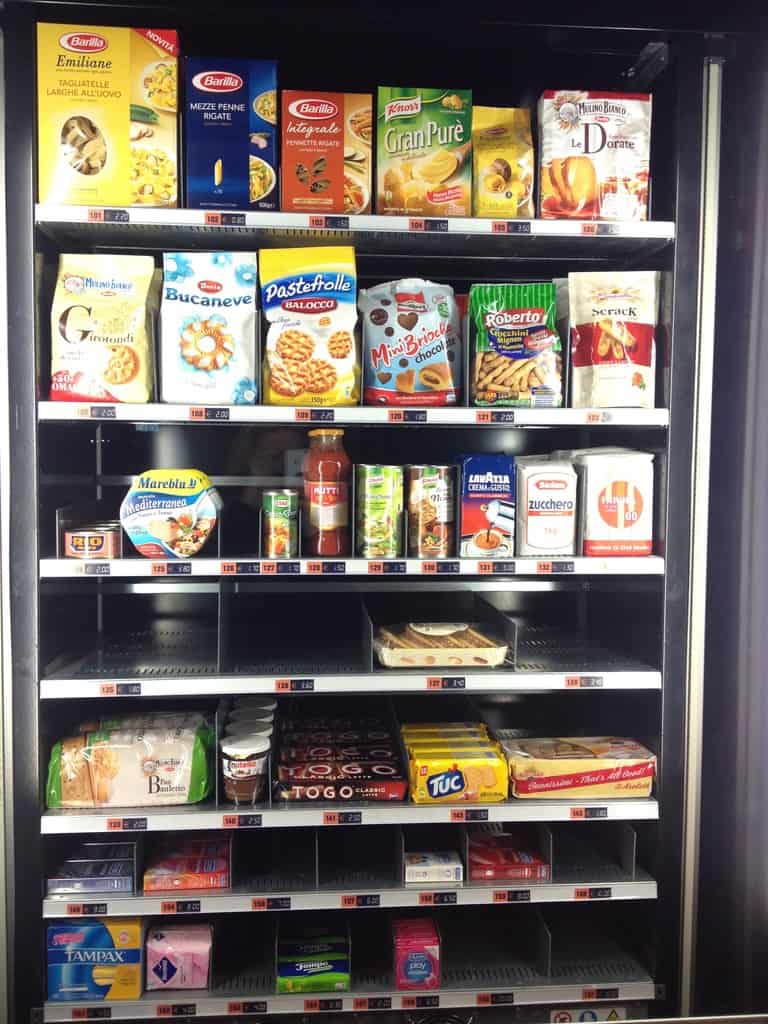 Italian vending machine that contains boxes of pasta (tagliatelle included) and Mutti tomato Passata,tampons, pads vegetable and chicken stocks, loaves of bread, 00 flour, condoms, cookies, tuna, sugar, coffee, and all kinds of other stuff