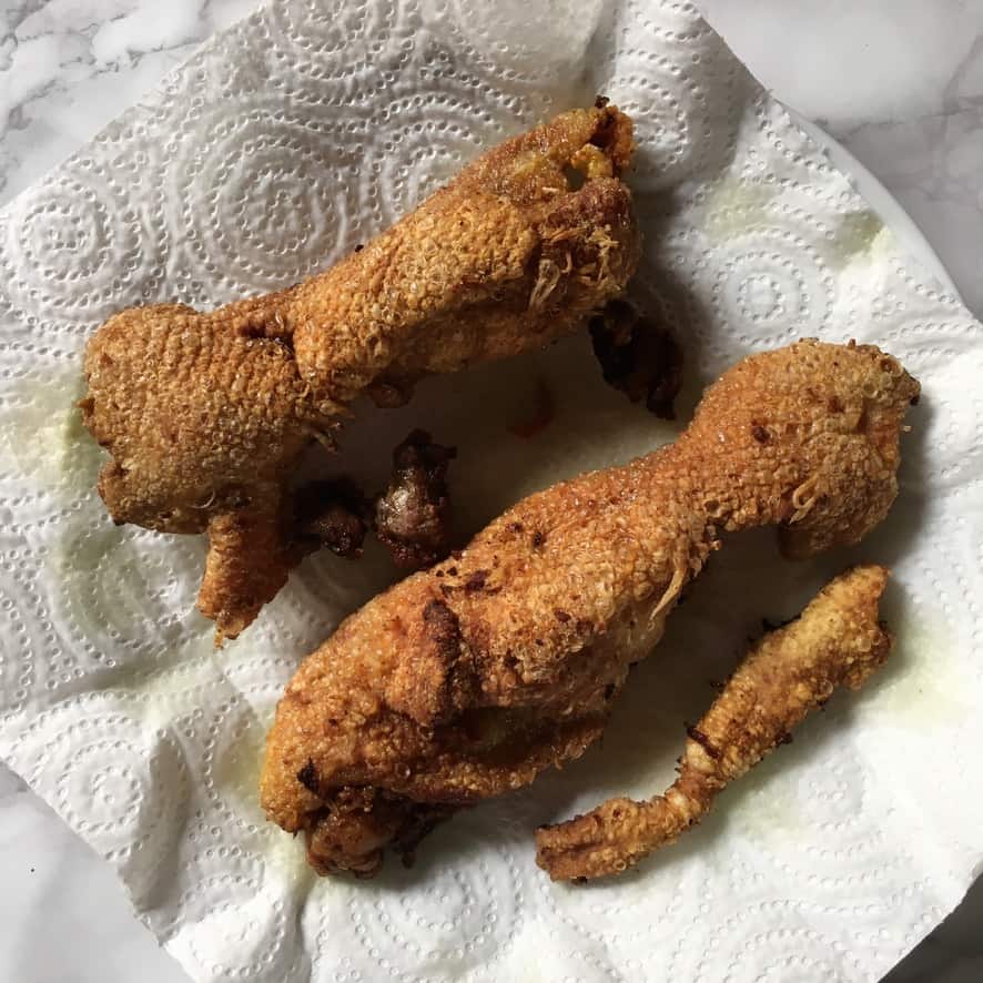 fried duck skin on paper towel-lined plate