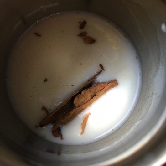milk with a small cinnamon stick, 1 clove, and a little freshly grated nutmeg