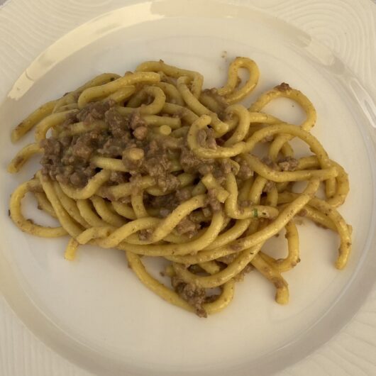 a plate full of bigoli pasta from a local trattoria