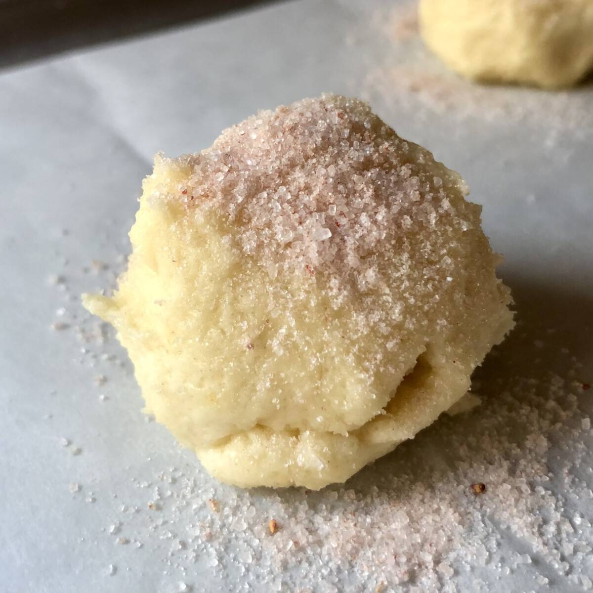 sugar cookie dough ball dusted with pink sugar