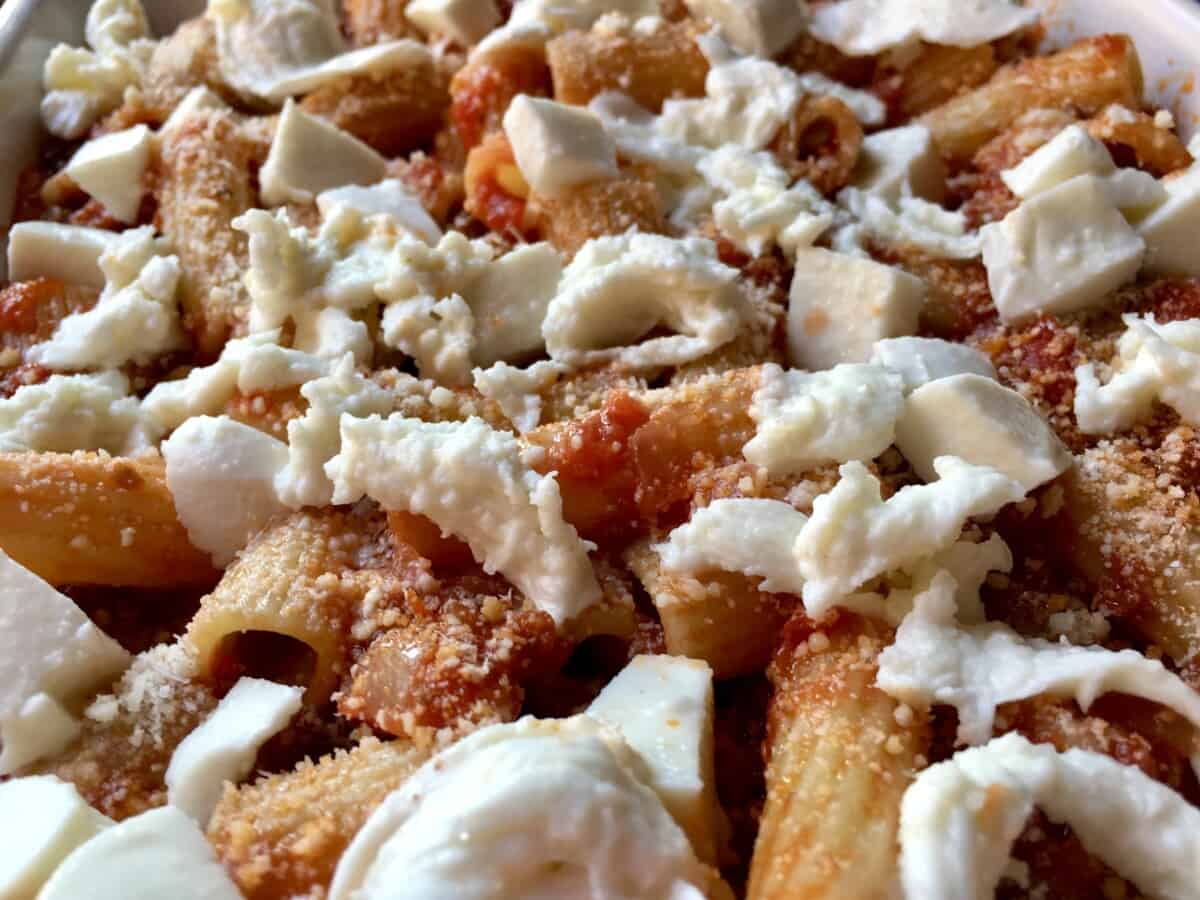 unbaked ziti with mozzarella chunks all over the top