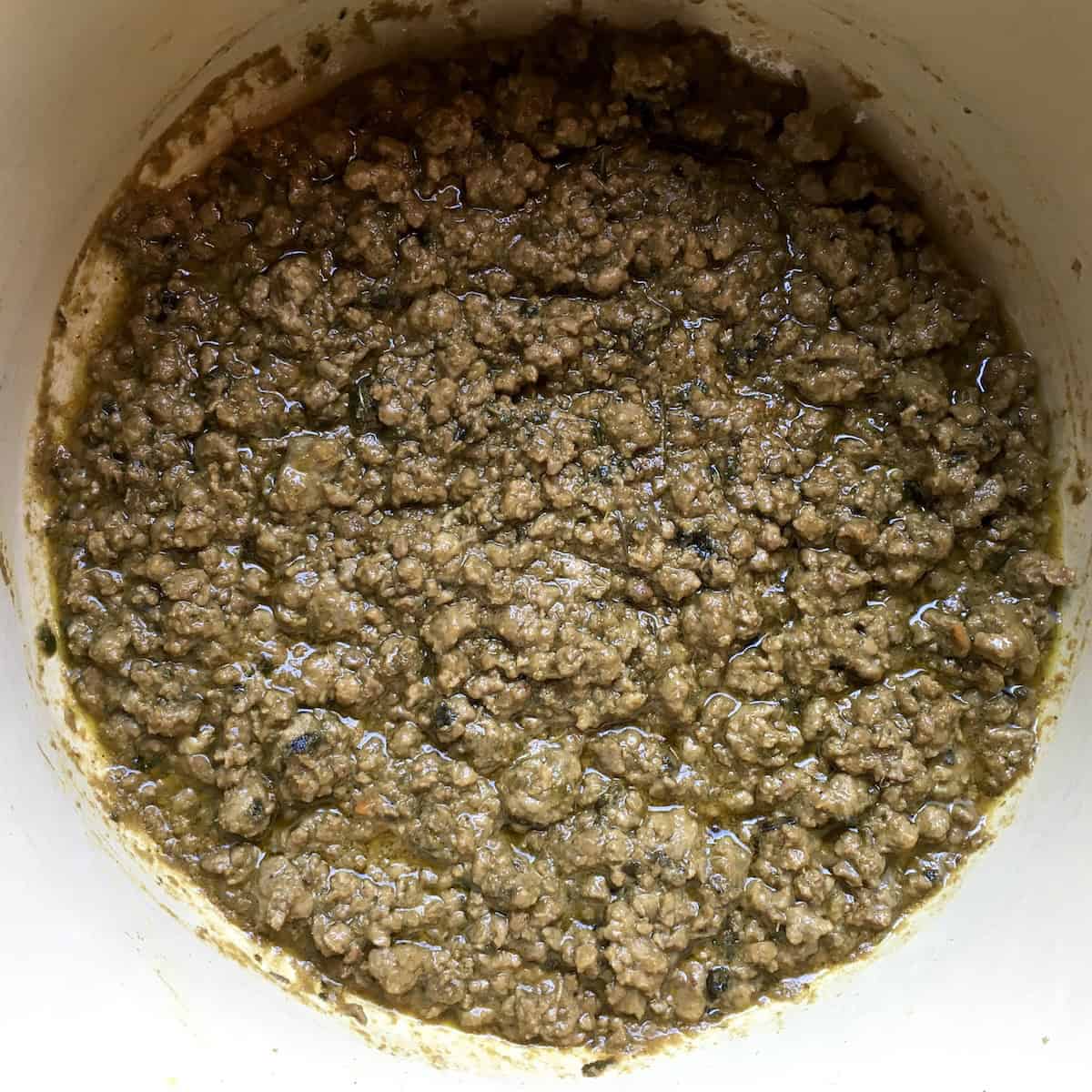 Duck ragu recipe finished in Le Creuset dutch oven ready to serve, homemade italian duck ragu in 7 quart braising pot, venetian duck ragu cooking complete and ready for bigoli pasta.