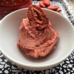 Strawberry butter in a bowl (looking like a scoop of ice cream) with a freeze dried strawberry garnish.