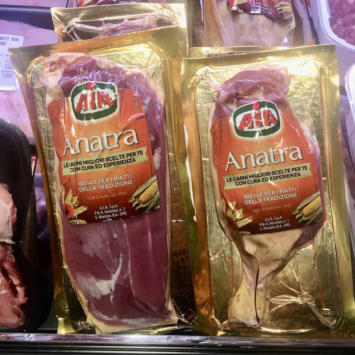 Duck breast and duck legs prepackaged at Italian grocery store for duck ragu recipe, fresh duck breast ragu and duck leg ingredients ready for making italian duck ragu.