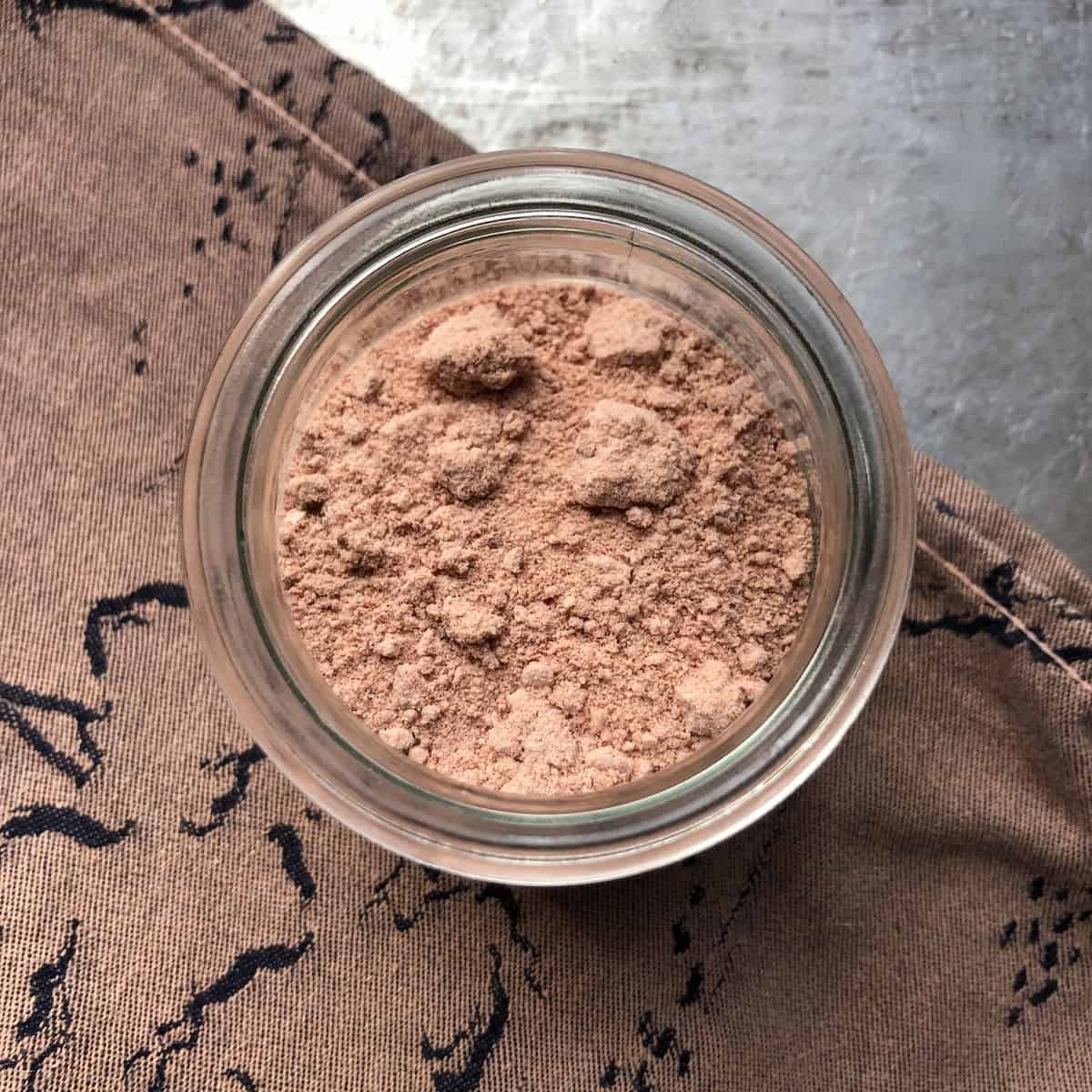 Homemade powdered strawberry sugar in a glass Weck canning jar for storage.