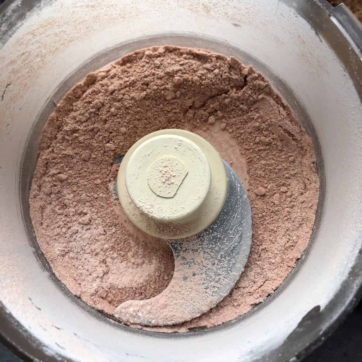 Freeze-dried strawberries and powdered sugar pulverized into a fine pink powder in a food processor.
